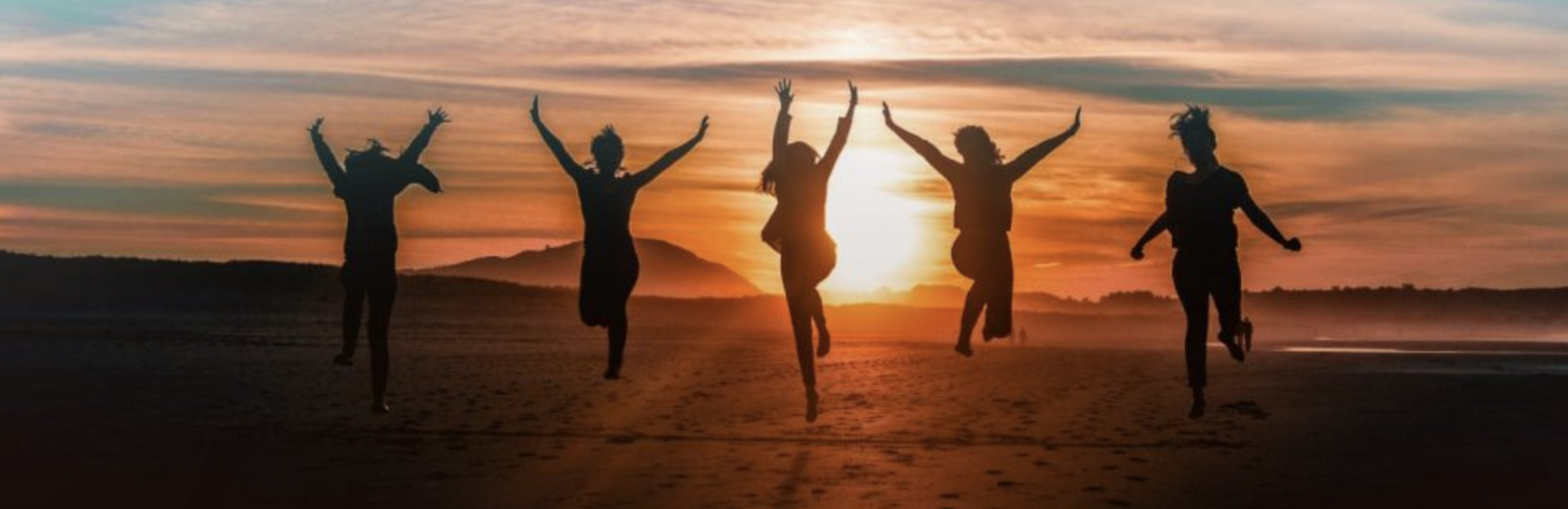 Five Women Jumping free at the same time in the sunrise